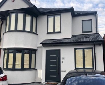 White house with dark double glazing installed in London
